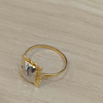 Angled view of a 916 gold two-tone Biscot V3 ring showing its rectangular design and circular gold band