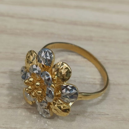 Angled view of a 916 gold two-tone floral cluster ring showing its raised flower and gold band