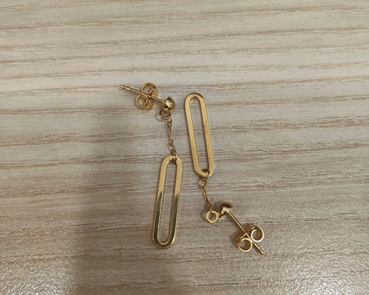 916 gold paperclip dangle earrings laid in opposite directions, showing open elongated drops and butterfly backs