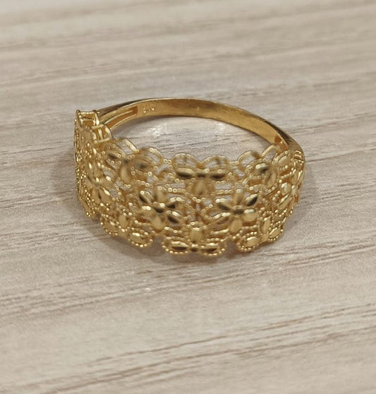 Angled front view of the 916 gold Serenity Petal ring showing the floral openwork face and plain back band