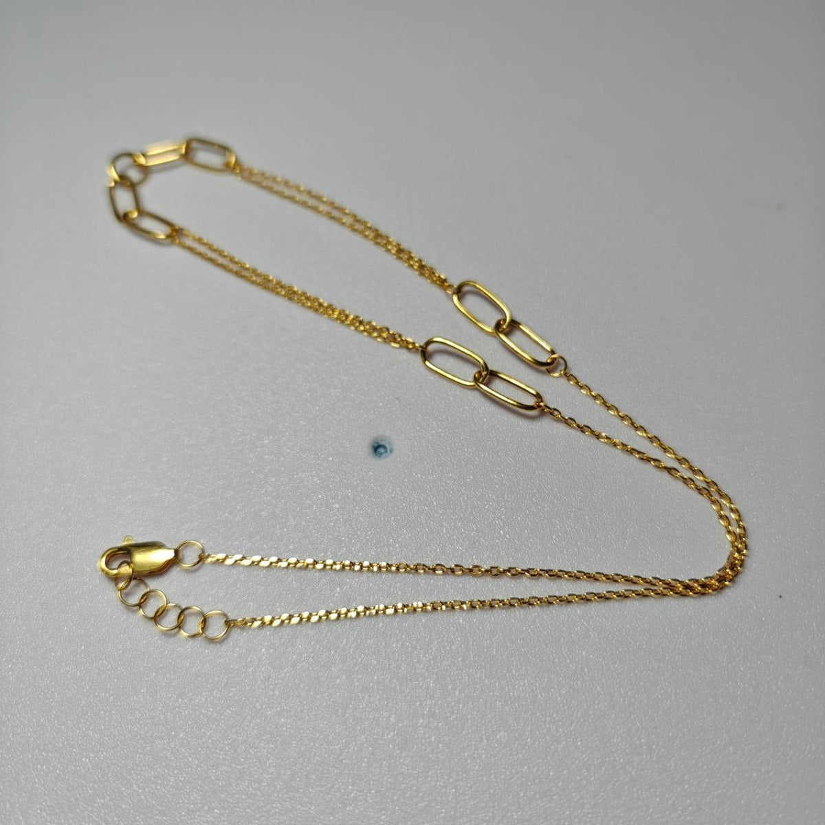 916 gold WanZi loop necklace laid flat with extender chain