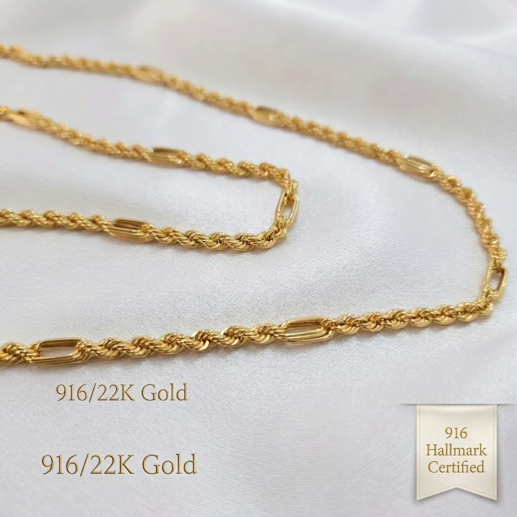 Detail of the alternating rope sections and elongated links of a 916 gold Hollow Rope C necklace on white fabric
