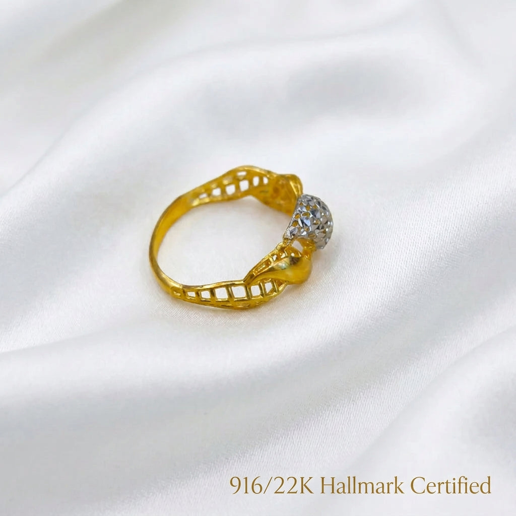 Rear angled view of 916 gold two-tone twist ring showing the inner band, openwork sides and faceted silver-coloured centre