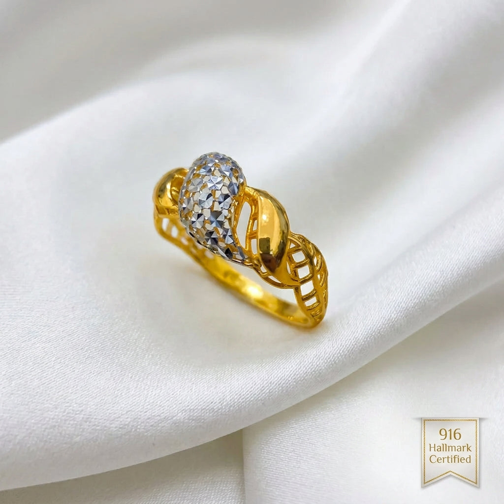 Angled view of 916 gold two-tone twist ring showing the raised faceted silver-coloured centre and openwork gold shoulders