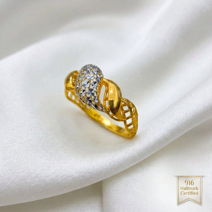 Angled view of 916 gold two-tone twist ring showing the raised faceted silver-coloured centre and openwork gold shoulders