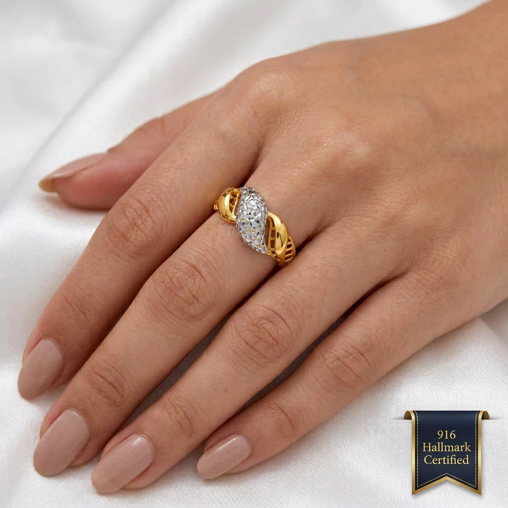 916 gold two-tone twist ring worn on a hand, showing the faceted silver-coloured centre and curved gold sections