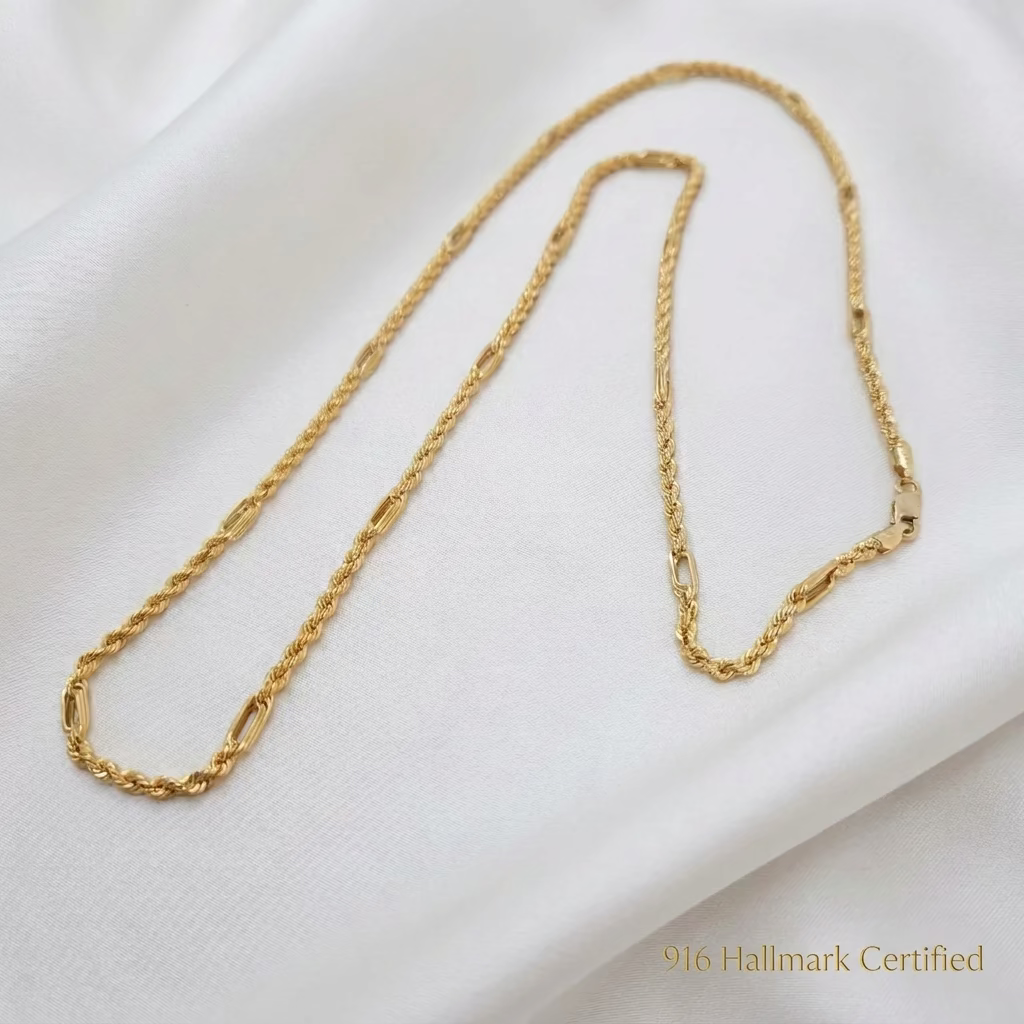 916 gold Hollow Rope C chain necklace in a long curved arrangement on white fabric, showing its clasp and alternating links