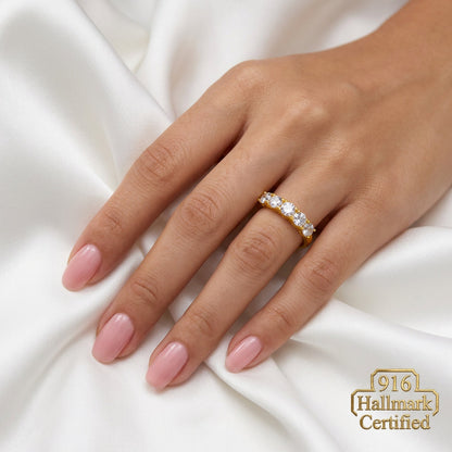 916 gold eternity-style ring worn on a hand, showing the row of round silver-coloured accents