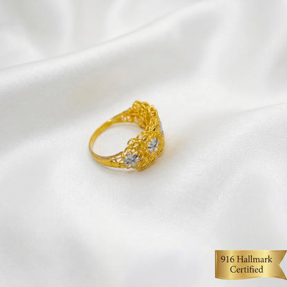 Side angle of the 916 gold Serenity Petal two-tone ring showing the floral panel and smooth band