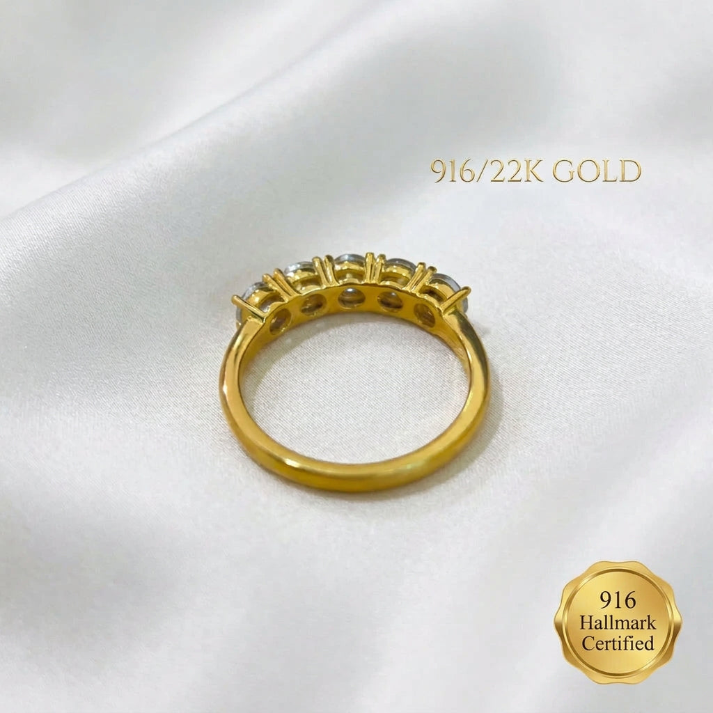 Underside of 916 gold eternity-style ring showing the open-backed settings and plain gold band