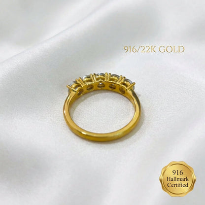 Underside of 916 gold eternity-style ring showing the open-backed settings and plain gold band