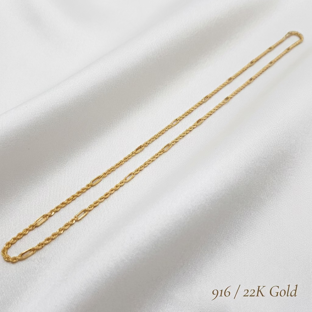 916 gold Hollow Rope C chain necklace laid diagonally on white fabric, showing the full chain and alternating link pattern