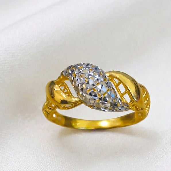 Front view of 916 gold two-tone twist ring with a faceted silver-coloured centre, curved gold sections and openwork sides
